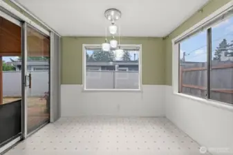 The breakfast nook/Dining space opens to the covered back porch, and is well lit by large windows.