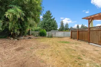 Large backyard with great rear tree coverage and space for gardening or playing.