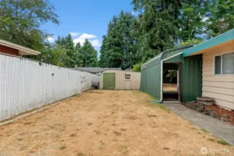 Large evergreens behind the home provide shade and privacy in the back.