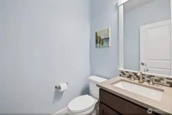 Stylish half bath, near entry, perfect for guests and everyday use.