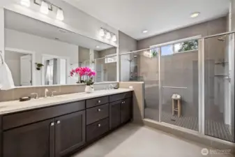 Elegantly designed primary bath leads directly to custom California Closet walk-in combining style and convenience.