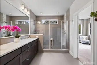 Elegantly designed primary bath leads directly to custom California Closet walk-in combining style and convenience.