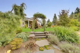 Beautiful archway leading from back patio to fire pit.