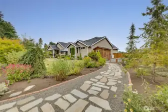 Gorgeous natural stone walkway enhancing the beauty of this immaculate, park-like 1+ acre oasis.