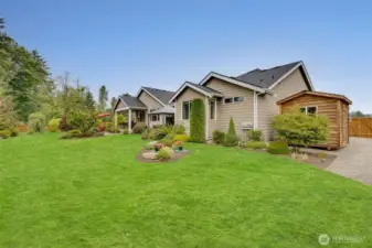 Lush lawn and professional landscaping enhance the beauty of this immaculate, park-like 1+ acre oasis.