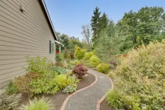 Side yard access with beautifully manicured landscaping.