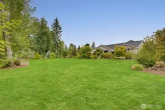 Lush lawn and professional landscaping enhance the beauty of this immaculate, park-like 1+ acre oasis
