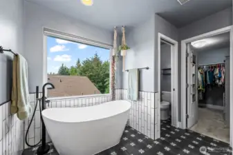 Updated primary bath with modern finishes and spa-like touches.
