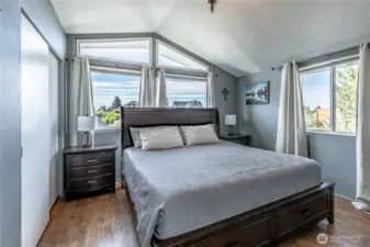 Primary bedroom has double closets and vaulted ceilings.
