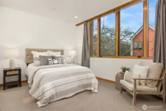A second bedroom with ensuite bathroom and west-facing windows