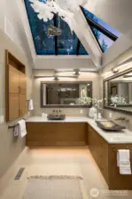 This spa like bathroom features custom hip skylights