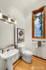 Half bath has a beautiful custom stained-glass window