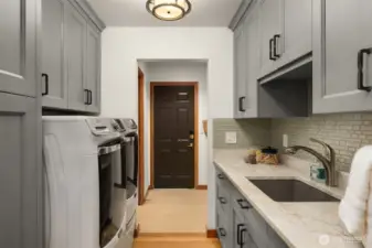 Laundry made easy with an abundance of storage and workspace.