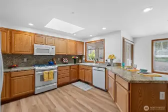 Spacious kitchen with beautiful LVP flooring, granite counter tops and a dual fuel stove.