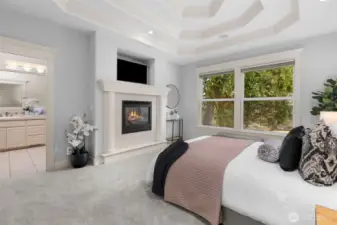 Primary suite on the main floor offers a private retreat with a gas fireplace and luxurious five-piece en-suite.