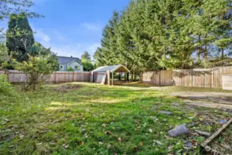 View from home toward carport and rear alley - check out the size of this yard!