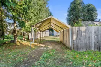 View from rear alley toward carport and back yard