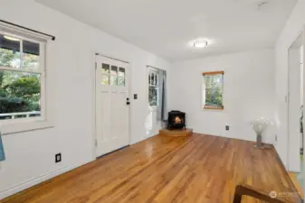 The living room features a gas stove and hardwood floors.