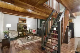 View from dining nook looking into living room.  Stairs to upper loft space.