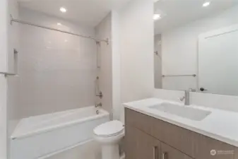 Main floor bathroom with tub and heated floors