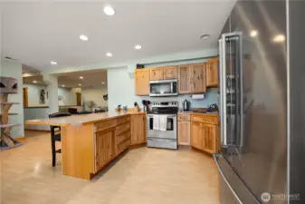 Vantage view from kitchen into living room with hallway pantry to the left.