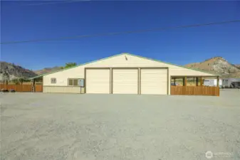 A view from outside, the south side of the structure with the entrance to the left/west and the four bay carport to the right/east.