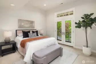 This bedroom up (facing front of the home) features vaulted ceiling and balcony.