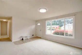 New LVP entry opens to cozy living space with large front window that fills the room with natural light