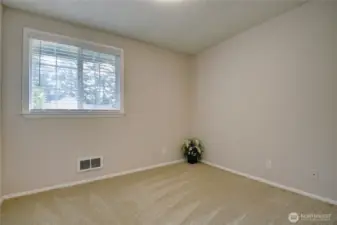 Bedroom 2 with fresh paint, new doors, and window blinds.