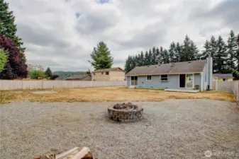 Large fenced backyard with fire pit - ideal for relaxing evenings and BBQs