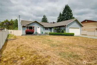 Pretty front yard with roses and irises adds curb appeal to this move-in ready 3 bedroom home