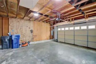 Good size two car garage with built-in shelving and pull-down ladder to overhead storage - room for tools, toys, and more!