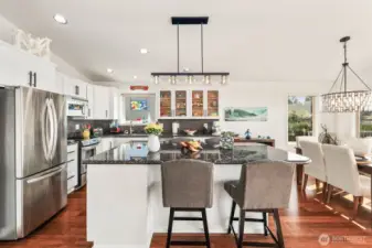 Eat-in kitchen with stainless steel appliances, slab granite counter tops, and room for 4 stools at the breakfast bar.