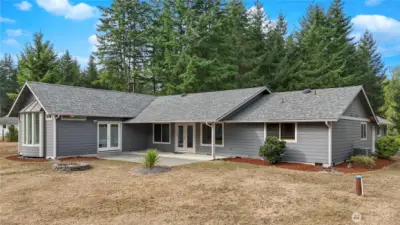 Enjoy year-round outdoor living with a spacious covered patio overlooking the backyard and fire-pit