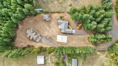Flat, accessible grounds surround the home and shops - while forested acreage invites exploration just beyond