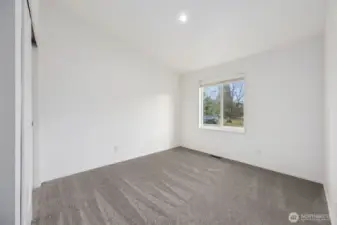 With a vaulted ceiling and generous window, this 2nd bedroom feels larger than expected. The plush mushroom carpet softens the space, and recessed lighting keeps everything feeling fresh and current. Whether it’s used as a bedroom, office, or flex space, the layout and finishes make it feel thoughtfully designed and comfortable.