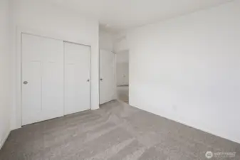 The closet view of bedroom #3.  It’s the kind of room that quietly works no matter how you decide to use it, and located right next to Bedroom #2 and the full main bathroom. Totally separate from the primary suite located on the entire other side of the home.