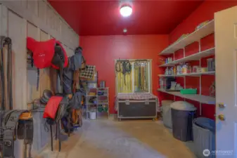 Another view of tack/feed/mechanical with grill covered window between stall and tack/feed/mechanical room to quietly observe injured animals or foaling mares.