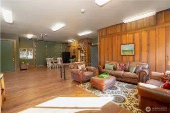 900 approximate square foot "gathering" room with garage type door opening to arena perfect for viewing equine activity - it also doubles as a loading dock to the home. The door on the left leads to the arena and door on the right leads to the kitchen.