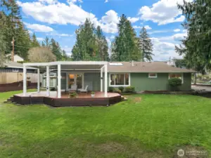 A view from the back of the home highlights the spacious 12,574 square foot lot.  Plenty of room for catch, fetch, and the yard space is equipped with invisible fencing.