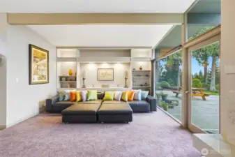 Family room with door to patio and back yard with hot tub.