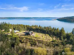 Perched high on the hill of your 5 acre sanctuary with the Hood Canal and Olympic Mountains framing your private retreat.