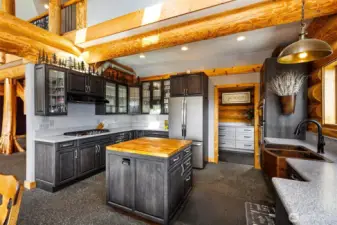 A Kitchen for the most discerning chef.  Gorgeous hammered copper sink, stunning cabinets and custom made, unique decorative iron crown accents set this space apart from anything you have ever experienced.