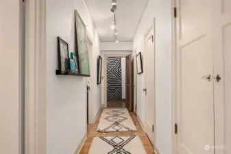 Hallway to bedrooms features numerous storage cupboards and is a great place to display art.