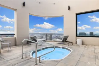 There is a hot tub on the rooftop deck area.