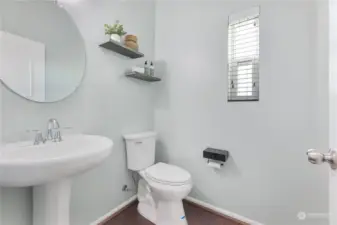 Main floor powder room with window and privacy fan