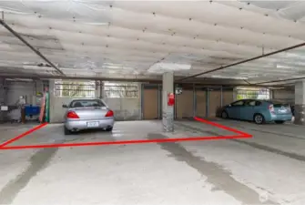 Two extra large parking spaces with storage in front.