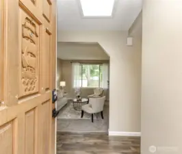 Front door entry facing the sunken living room. Bedrooms are to the left and the kitchen is to the right of the entry.