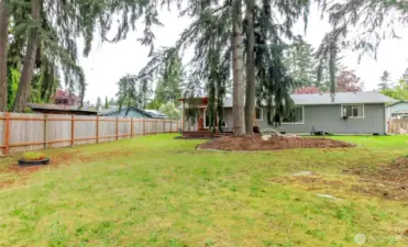 Deep yard with plenty of room for gardening or playing.