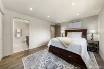 The Primary Suite offers both comfort and convenience with direct access to the ensuite bathroom. Take note of the engineered hardwood floors that carry through the home for a cohesive, elevated feel.